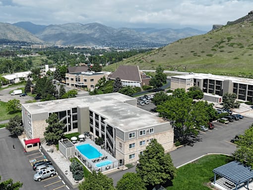 A large building with a pool in the middle of a parking lot.