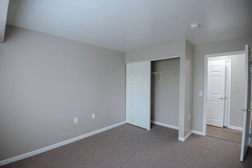 A room with a carpeted floor and white walls.