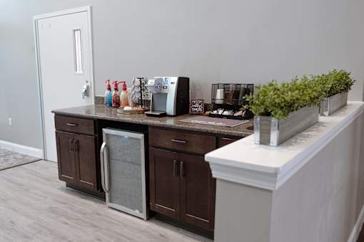 A kitchen with brown cabinets and a white counter.