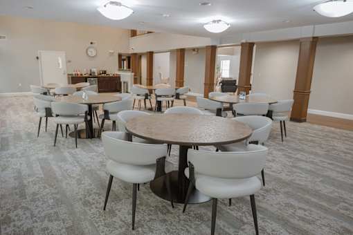 A conference room with a large table surrounded by chairs.