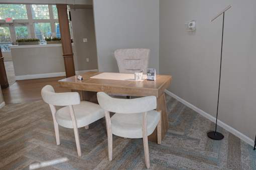 A room with a desk and two chairs.