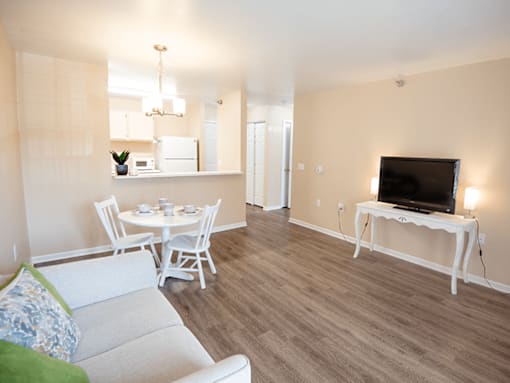 A living room with a white couch and a television.