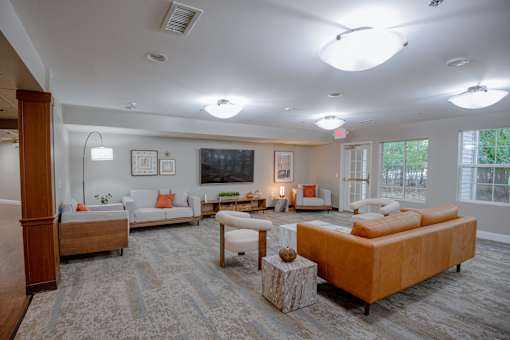 A living room with a large couch and a television.