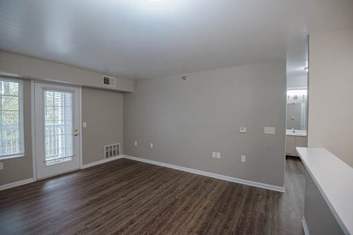 A room with wooden floors and white walls.