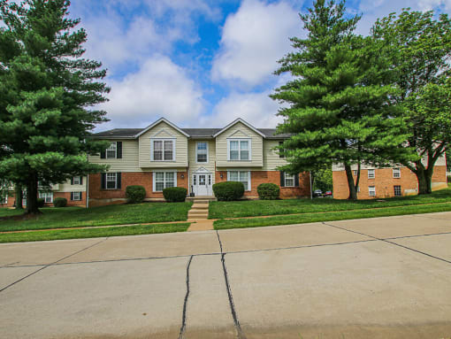 apartment building with trees in front of it
