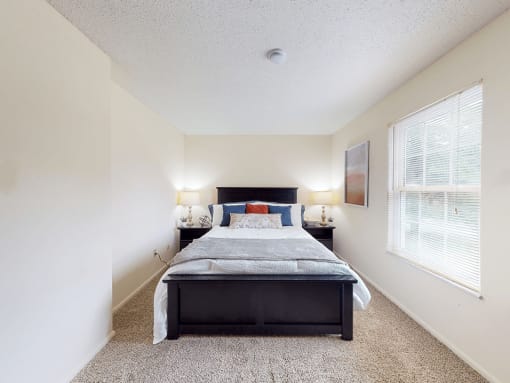a bedroom with a bed and two nightstands