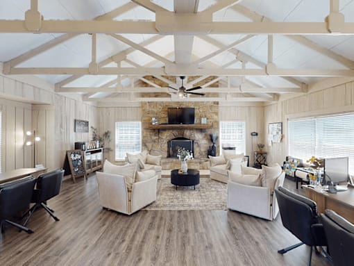A living room with a fireplace and a television.