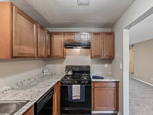 a kitchen with wood cabinets and a black stove