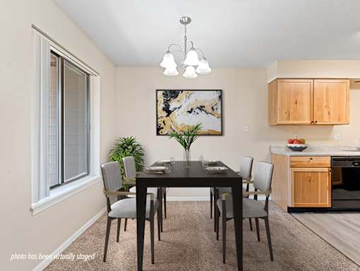 A dining room with a table set for four.