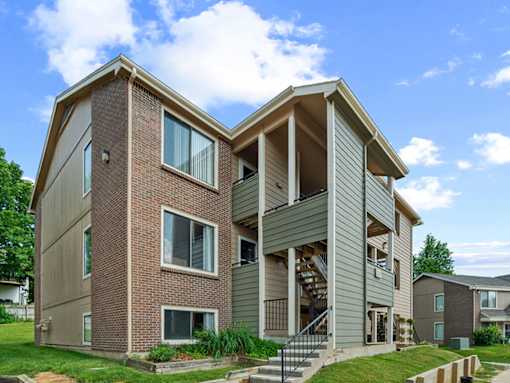 A modern two-story house with a balcony on the second floor.