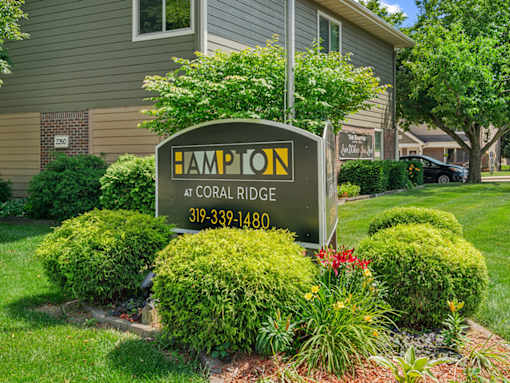A sign for Hampton at Coral Ridge with a phone number on it.