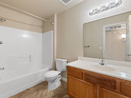 A bathroom with a white toilet and a white sink.