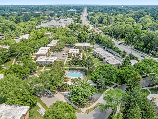 A bird's eye view of a residential area with a swimming pool.