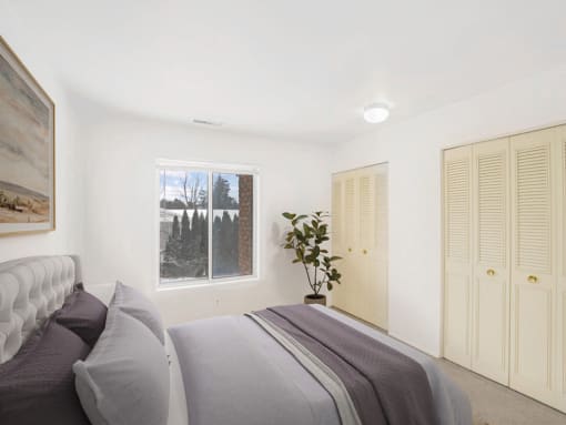 a bedroom with a large bed and a large window