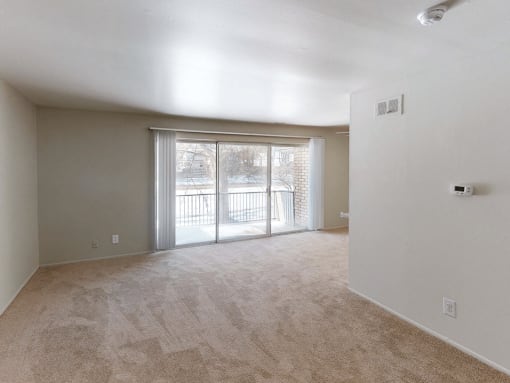 a bedroom with a sliding glass door leading to a balcony