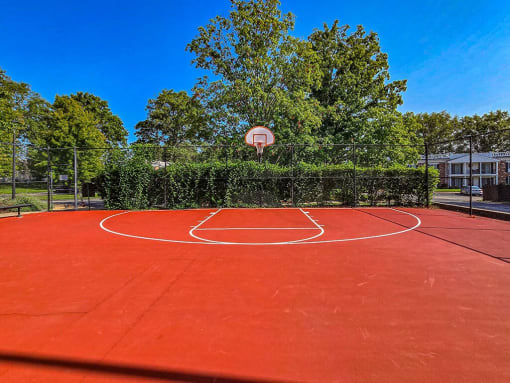 red basketball court at apartment complex