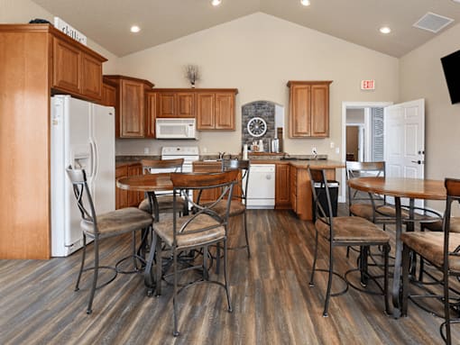 A kitchen with wooden cabinets and a white refrigerator.