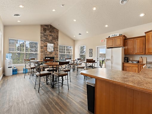 A kitchen with a table and chairs in the middle of the room.