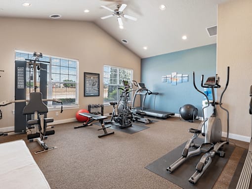 A spacious home gym with a variety of exercise equipment.