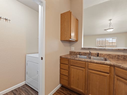 A bathroom with a white cabinet and a brown counter.