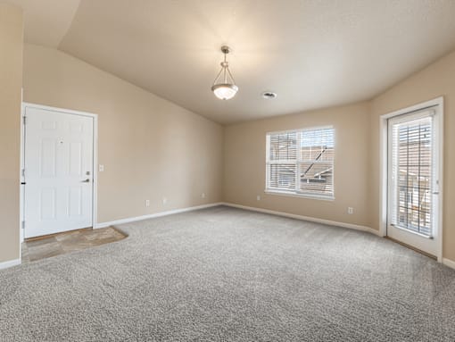 A room with a carpeted floor and a ceiling light.
