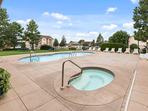 A large outdoor swimming pool with a slide.