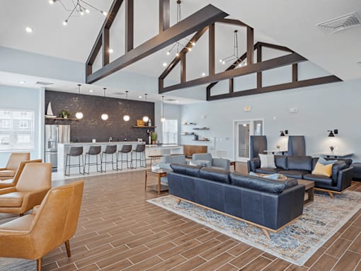 A modern living room with a blue couch and a wooden floor.