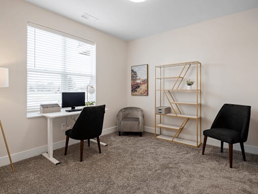 A room with a desk, chair, and shelf.