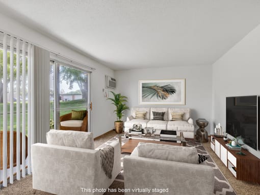 a living room with a couch and chairs and a television