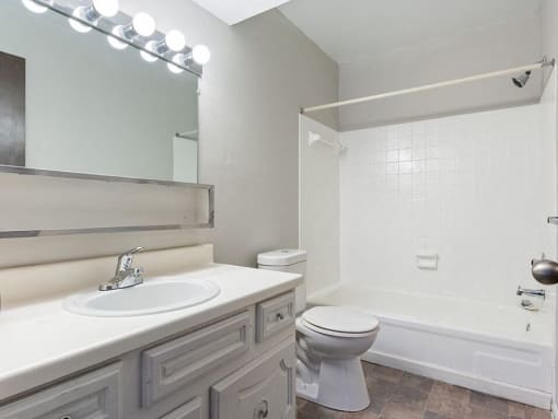 a bathroom with a sink toilet and a shower