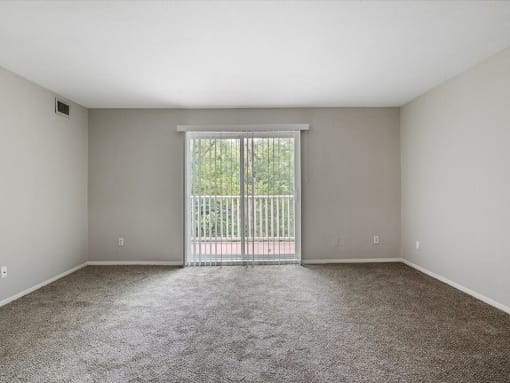 apartment living room with a sliding glass door to a balcony