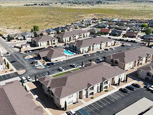 A large housing development with a swimming pool in the middle.
