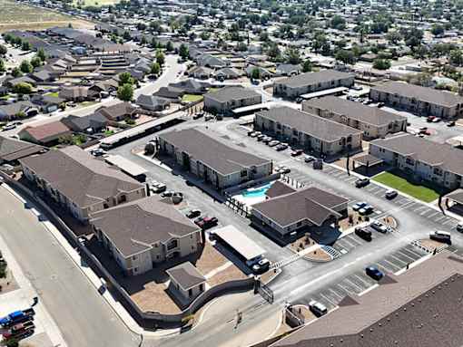 A bird's eye view of a residential area with houses and roads.