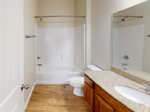 a bathroom with a toilet and a shower and a sink