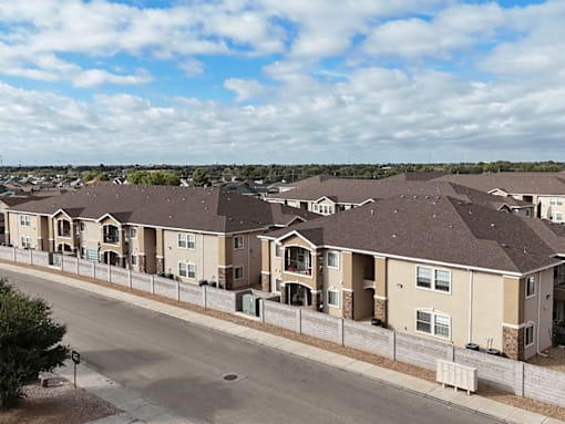 A row of houses with a street in front.