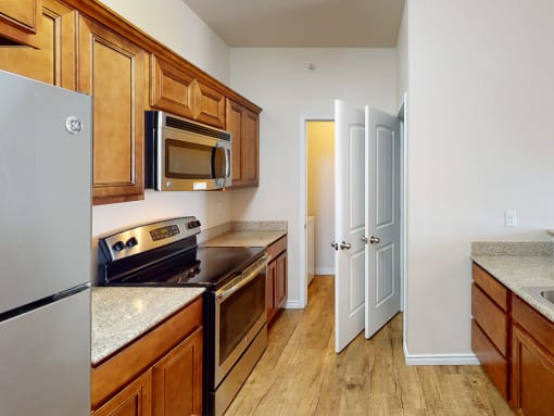 a kitchen with a stove and a refrigerator