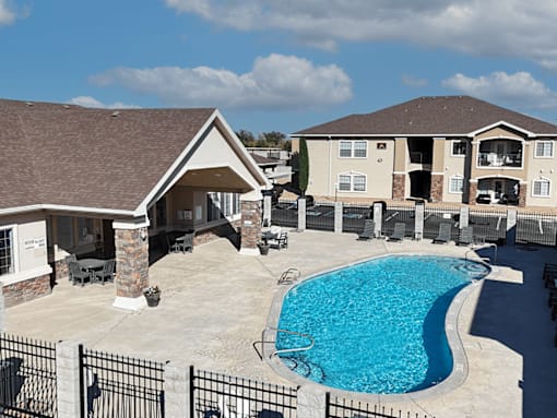A swimming pool in a backyard with a house in the background.
