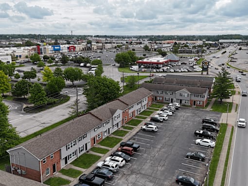 A parking lot with cars and a building in the background.
