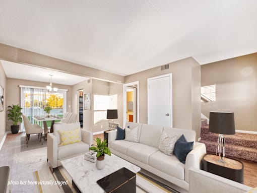 A living room with a white couch and a coffee table.