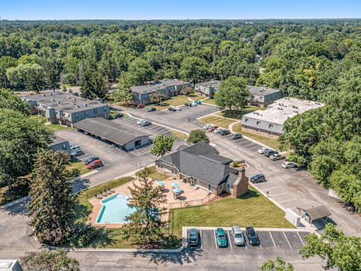 A bird's eye view of a residential complex with a swimming pool.