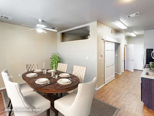A dining room with a round table set for six.