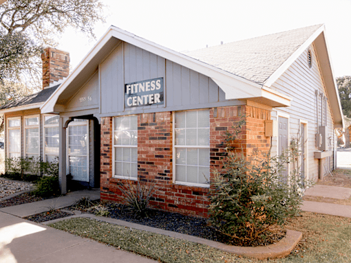 A small building with a sign that says Fitness Center.
