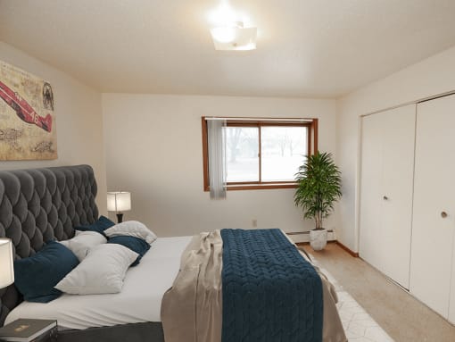 apartment bedroom with a large bed and a window