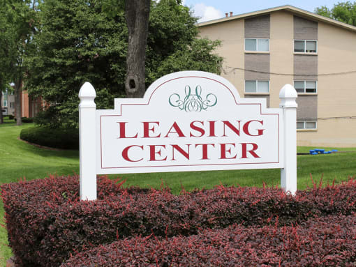 the leasing center sign in front of apartment building