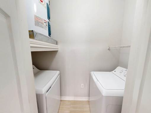 A small laundry room with a washer and dryer.