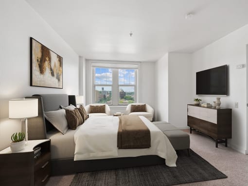 a bedroom with a large bed and window