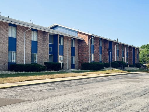 an empty street in front of a brick building