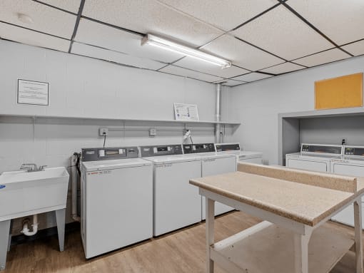 a kitchen with white appliances and a table