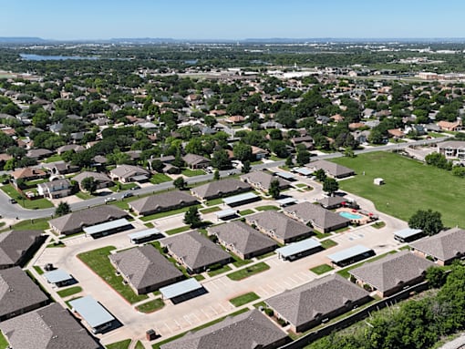 A bird's eye view of a residential neighborhood with houses and streets.