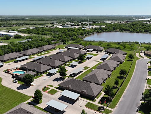 A suburban neighborhood with houses and a pool.